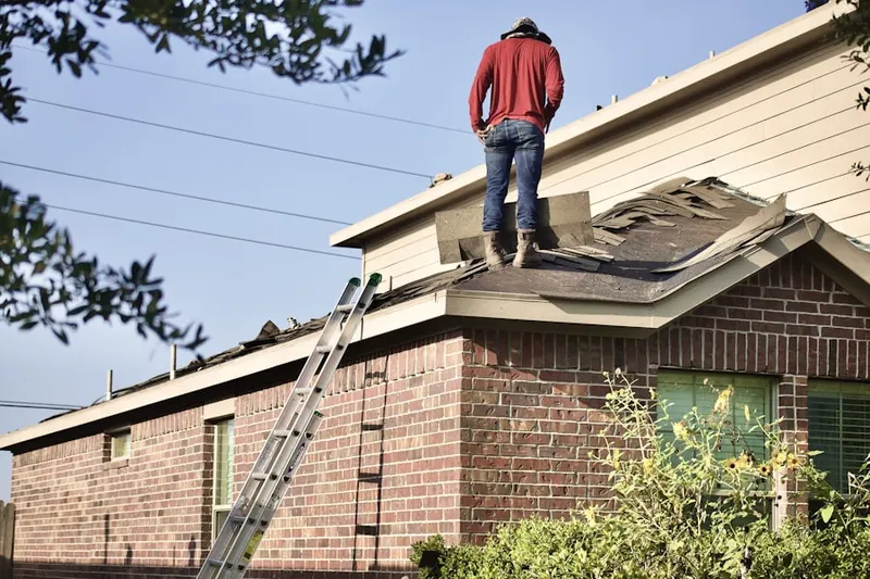 Professional roofer working on a residential roof in South Auburn